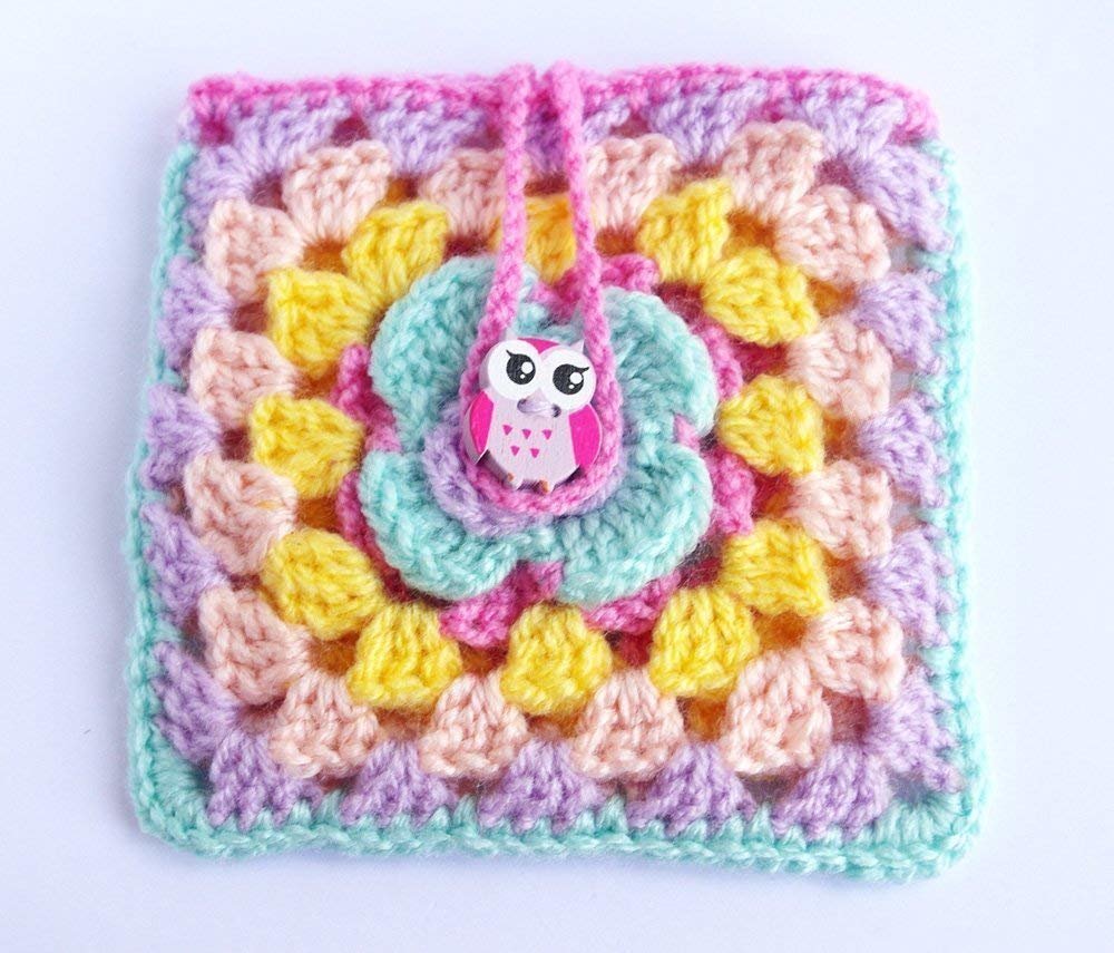 "Brighten up your day with our vibrant Crochet Pouch featuring a whimsical rainbow owl design."