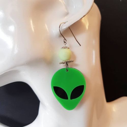 "Make a statement with our eye-catching Alien Earrings, featuring quirky alien pendants for a fun and playful look."