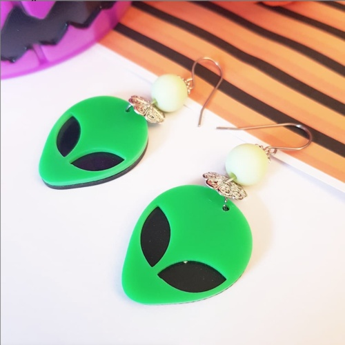 "Channel your extraterrestrial chic with our Green Alien Earrings, crafted with care for a truly out-of-this-world accessory."