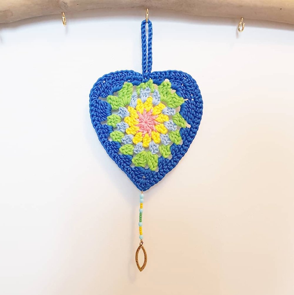 "Make a statement in any room with our Blue Boho Heart Crochet Décor, featuring delicate glass bead and brass pendant accents for an extra touch of sophistication."