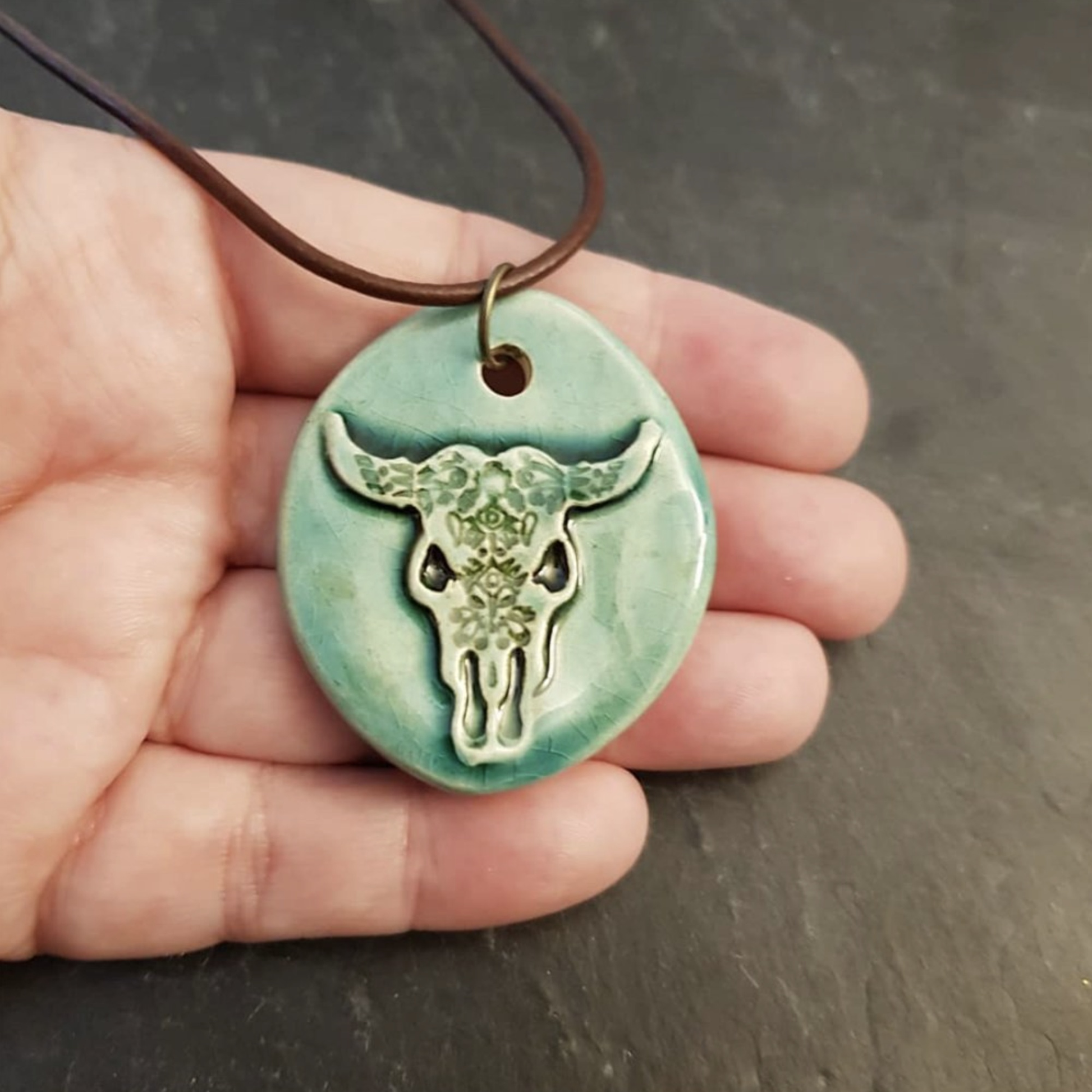 "Stand Out in Style with our Eye-Catching Cow Skull Necklace."