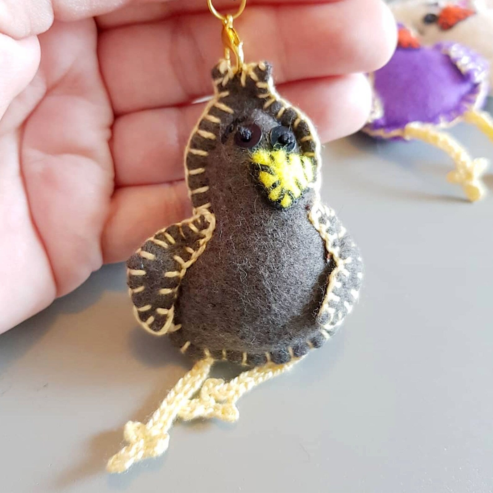 "Experience the charm of handmade artistry with CocoFlower's Felt Bird creation."