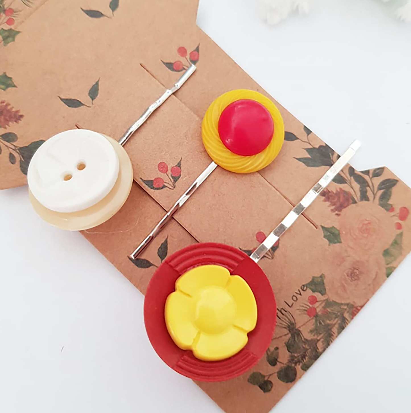 "Elevate your hairdo with Button Bobby Pins! Handcrafted from repurposed vintage buttons, these pins offer a chic and eco-friendly way to style your hair."